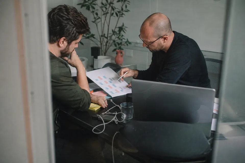 Two engineering leads comparing JavaScript candidate scorecards